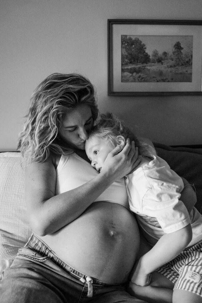 An expecting mama hugs her son during an in-home maternity session in Louisville, KY