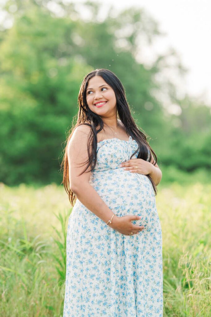 An expectant mama smiles at Beckley Creek Park in Louisville for her summer maternity session.