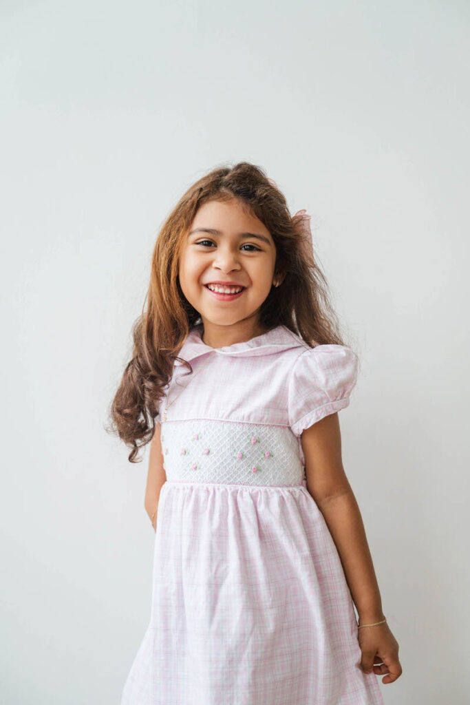 Four year old girl smiles at the camera during her Louisville mini session.