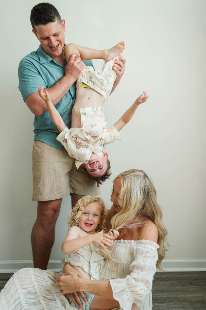 An expecting family plays with their kids during their Louisville maternity session.