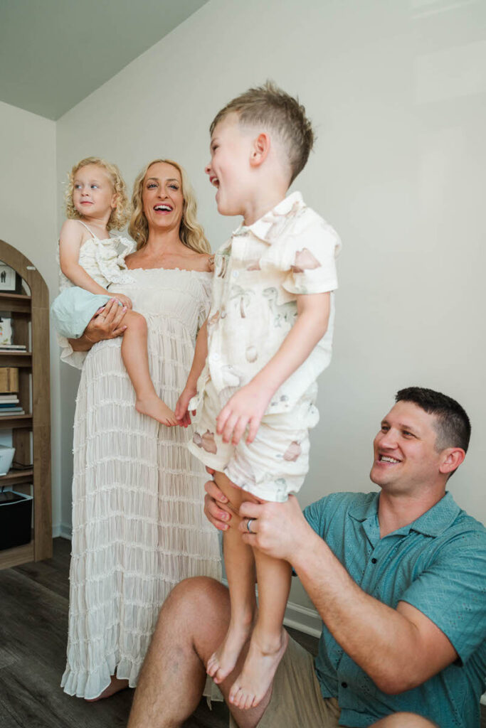An expecting family plays with their kids during their Louisville maternity session.