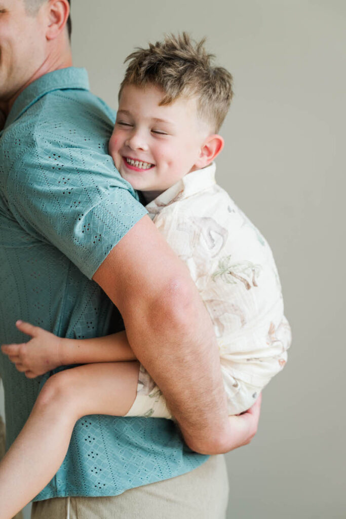 Dad gives his son a piggy back ride during their Louisville in-home session.