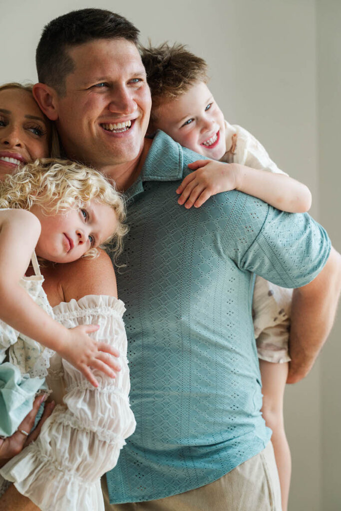 An expecting family plays with their kids during their Louisville maternity session.