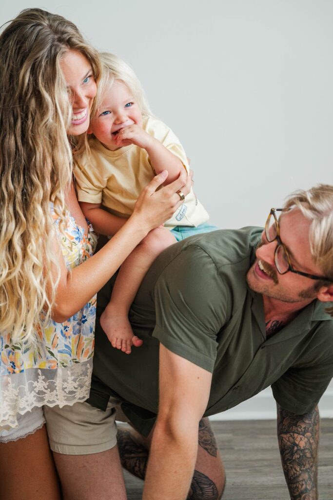 Mom hugs toddler and they laugh during their Louisville in-home photo session.