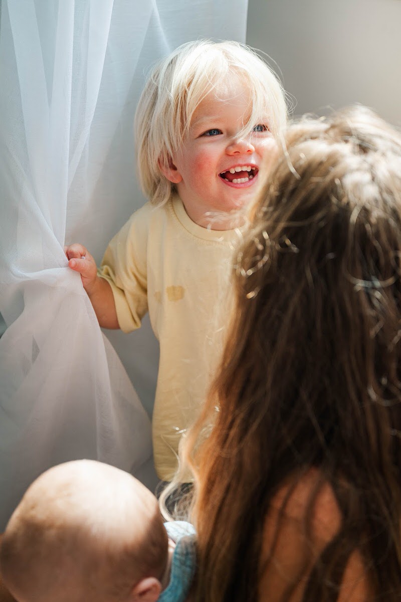 Mom and son play during their in-home photo session.