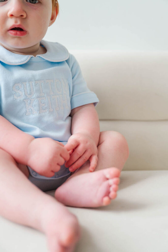Baby's little hands and feet captured for his Louisville six month photos.
