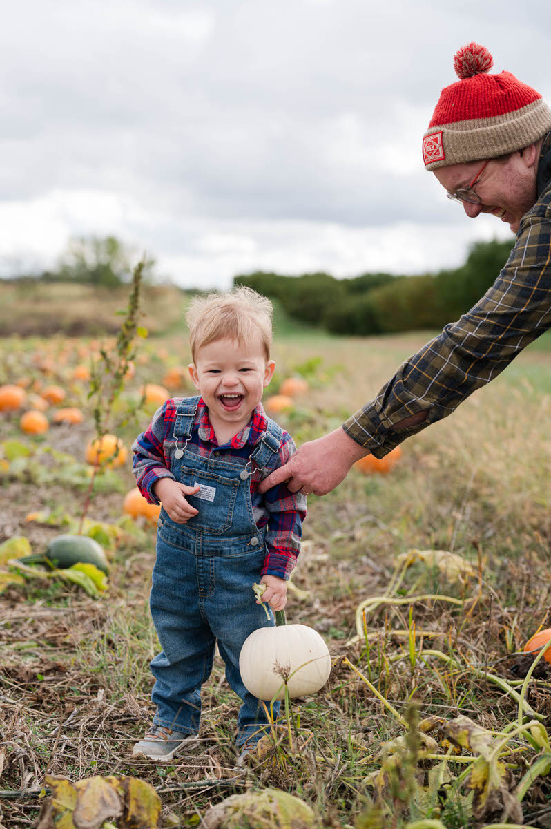 Dad and son pick pumpkins at Huber's Orchard and Winery.