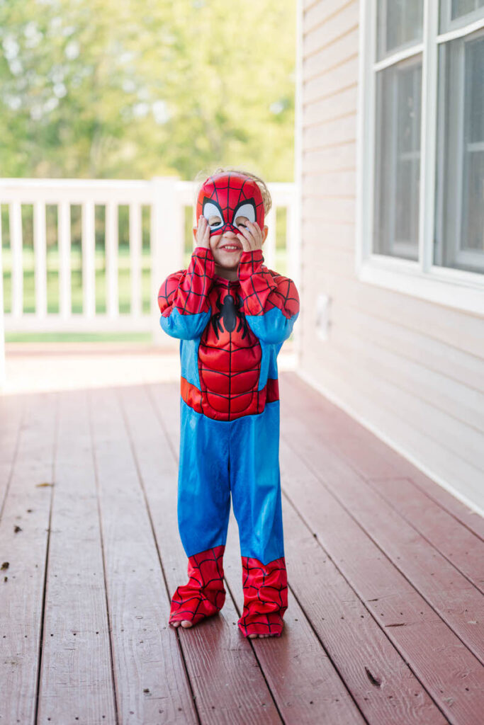 Boy smiles in his Spiderman costume for Halloween in Louisville.