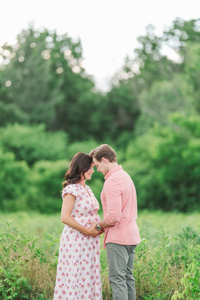An expecting mom and dad share a private moment during their maternity session at Beckley Creek Park in Louisville.