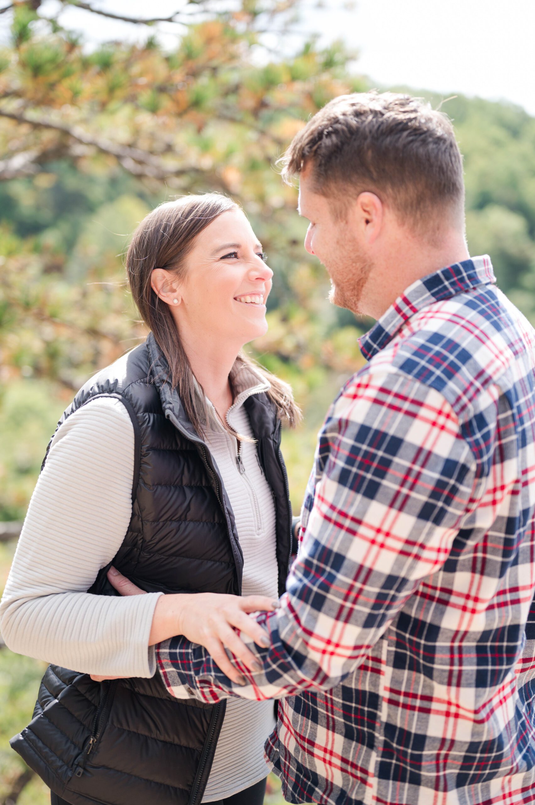 Engaged couple stands at overlook in Red River Gorge