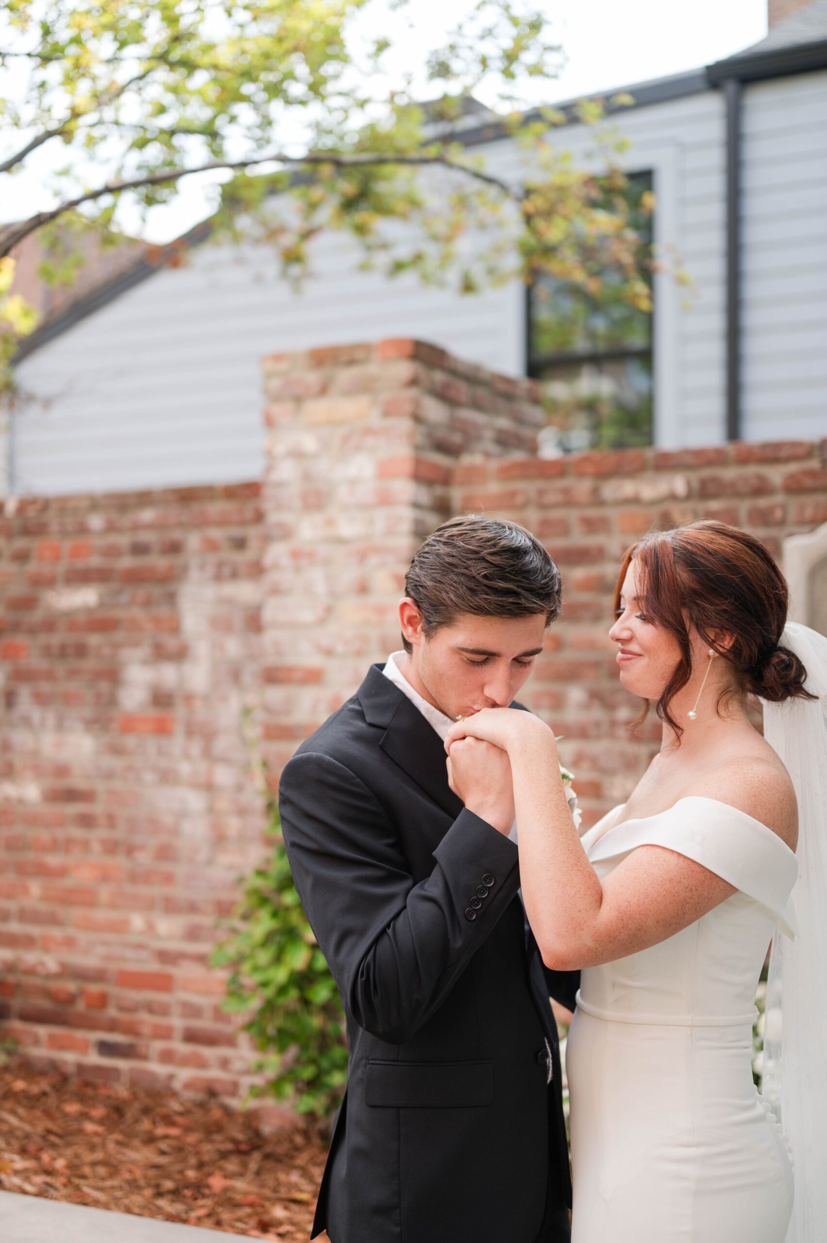 Wedding couples kisses hands.