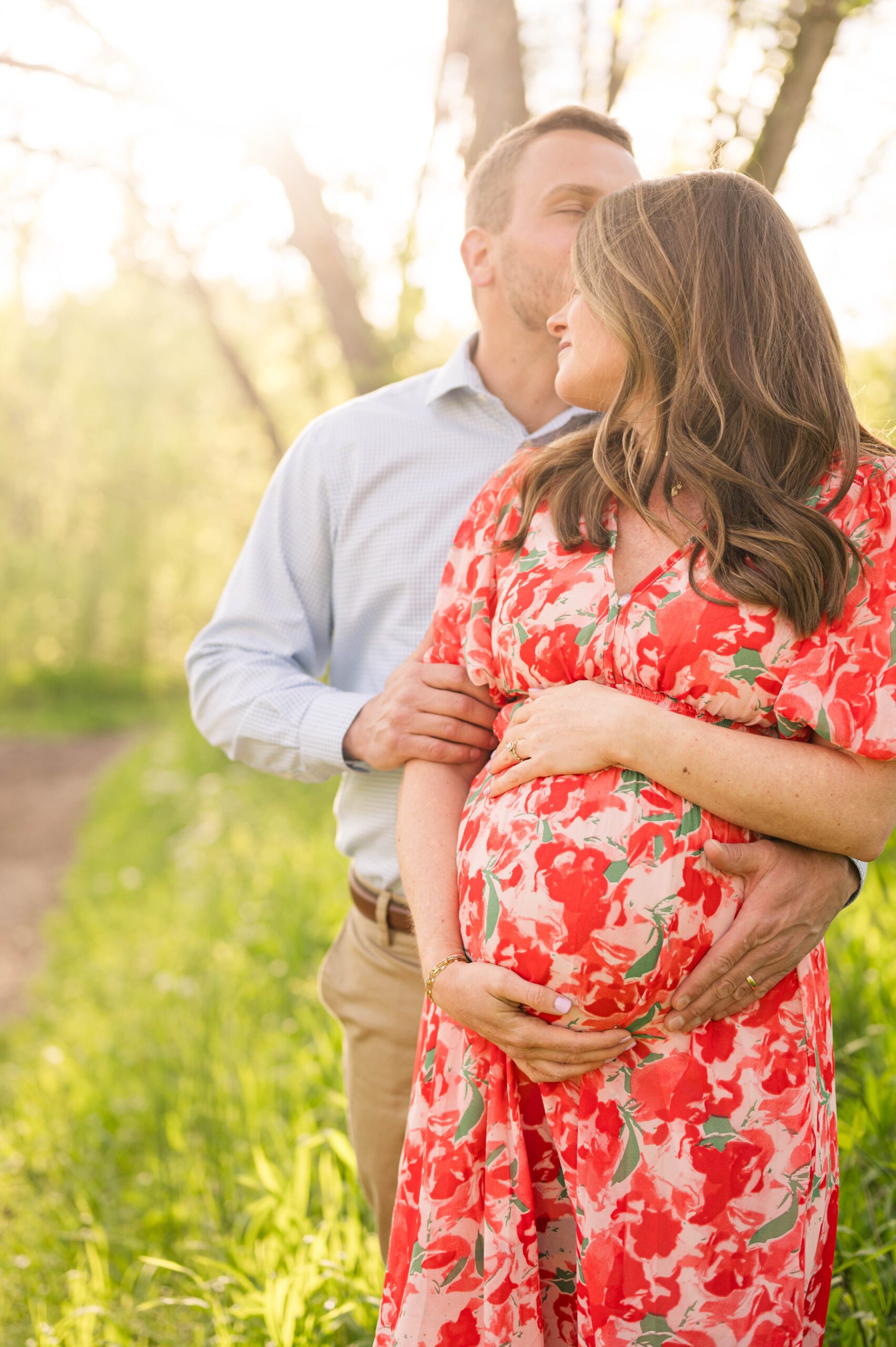 Expectant couple poses at golden hour for their maternity session