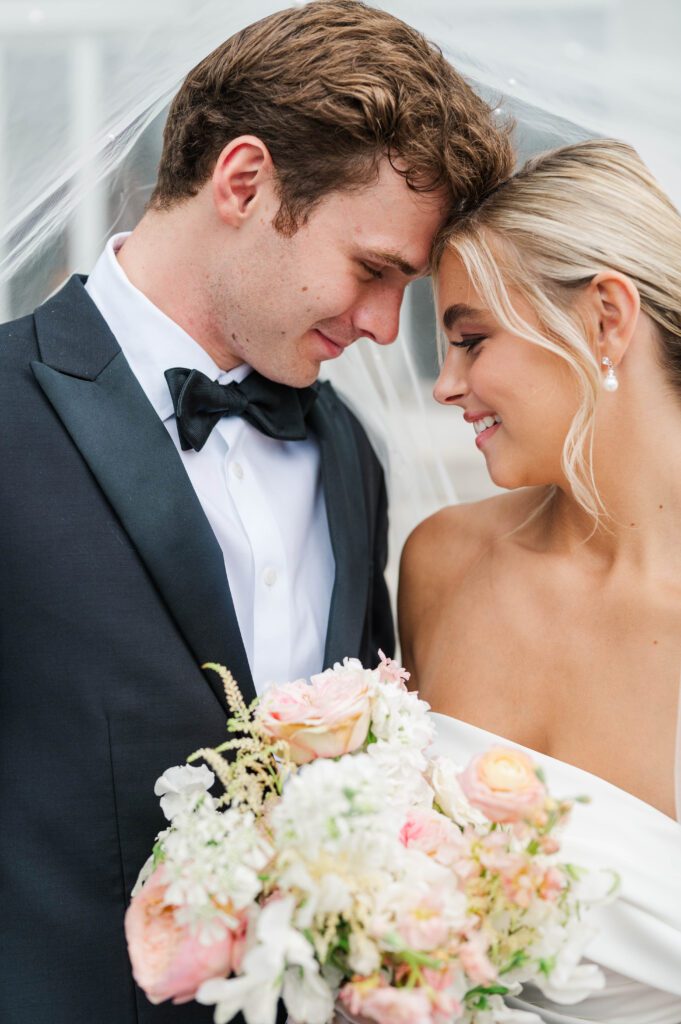 Bride and groom pose in front of Laurel Court on their wedding day in Cincinnati