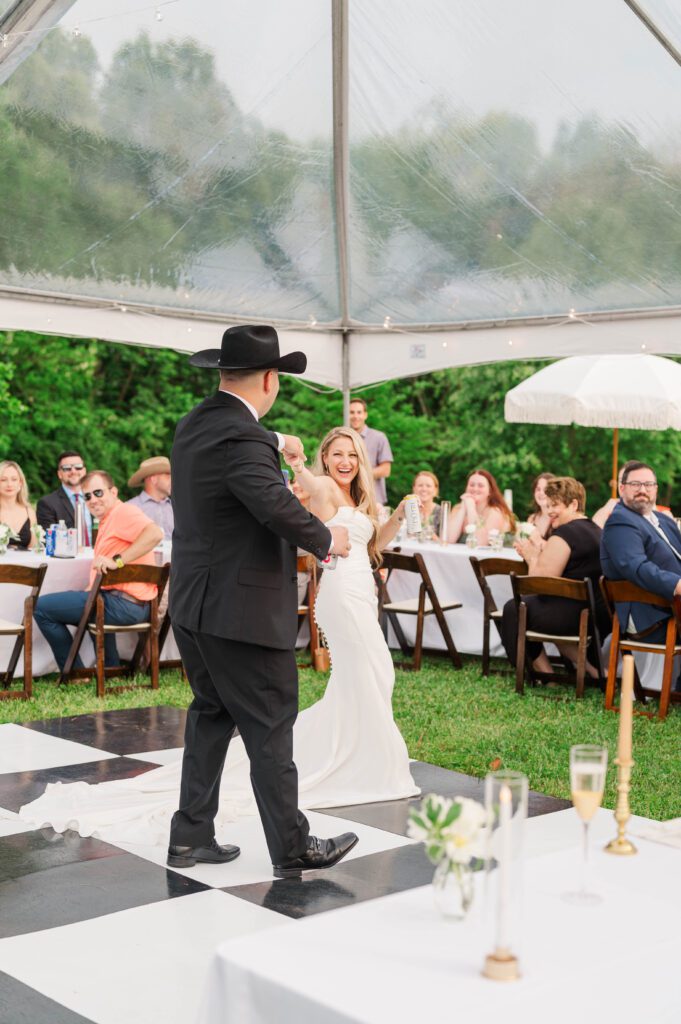 Bride and groom walk in for their wedding reception entrance