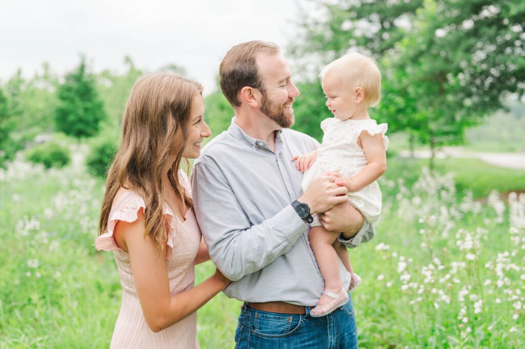 Mom and dad look at their daughter during their Louisville family session