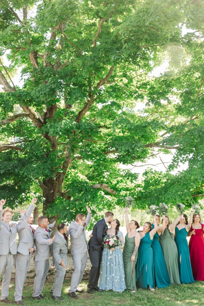 The bridal party celebrate after the ceremony on a Kentucky farm wedding day. 