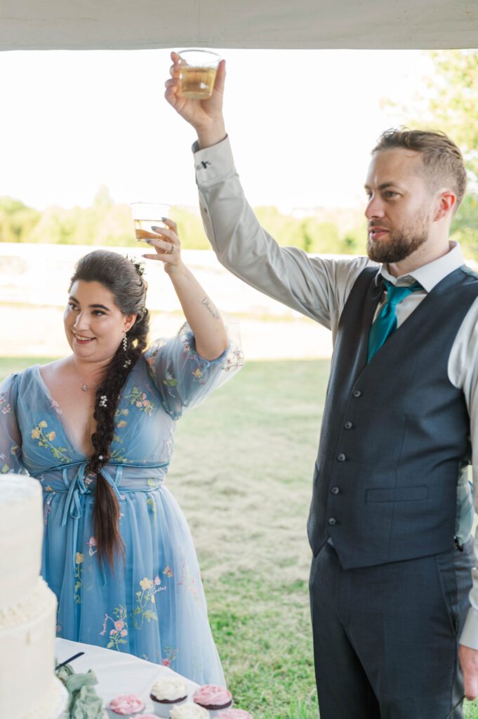 Bride and groom toast after their cake cutting. 