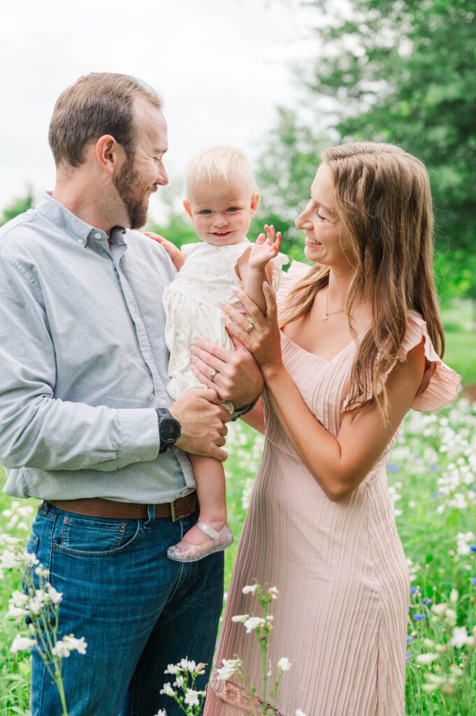 Mom and dad play with baby during their family photo sessions