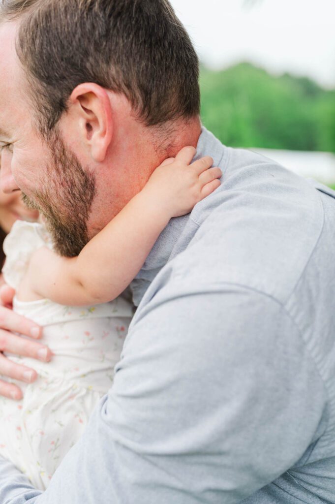 Baby gives her dad a hug during their family session