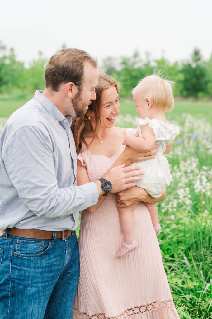 Mom and dad play with their daughter during their Louisville family session