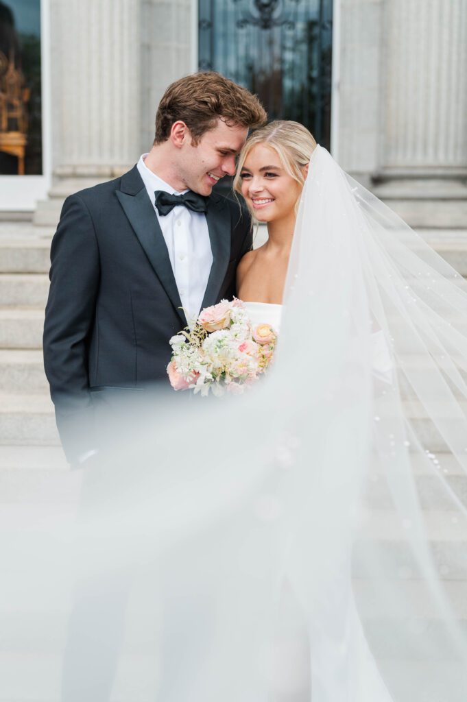 Bride and groom pose in front of Laurel Court on their wedding day in Cincinnati