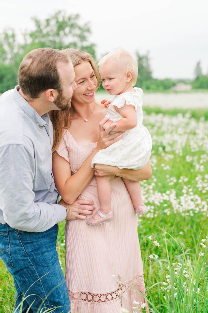 Mom and dad play with baby during their family photos in Louisville