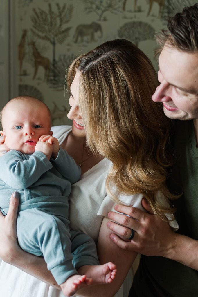 Family stands together in the nursery with their 3 month old for their Louisville in-home family session