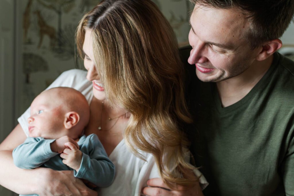 Family stands together in the nursery with their 3 month old for their Louisville in-home family session