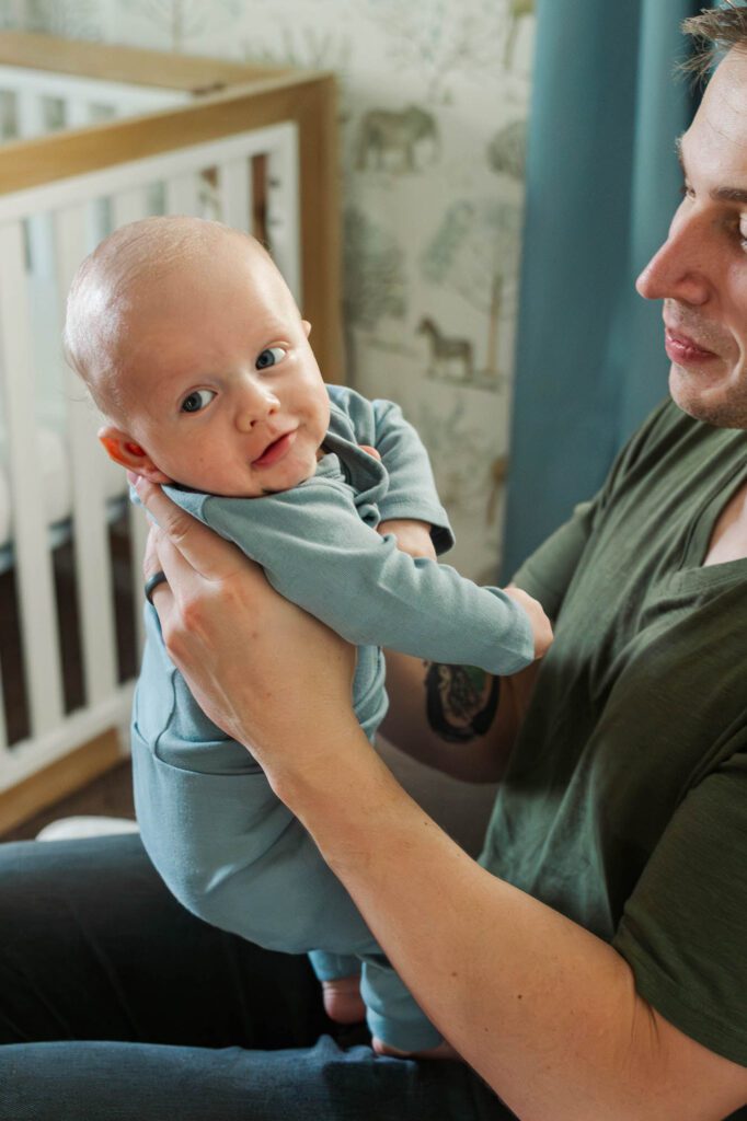 Dad holds his son during his three month milestone session