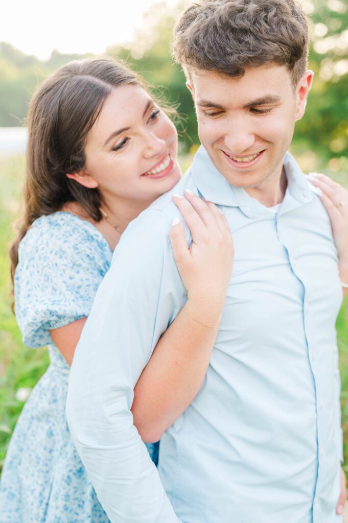 Couple stands together in a field of wildflowers at Beckley Creek Park for their Louisville engagement session.