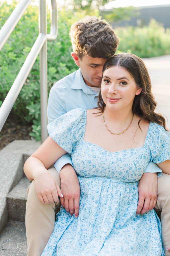 Couple sits together at Beckley Creek Park for their Louisville engagement session.