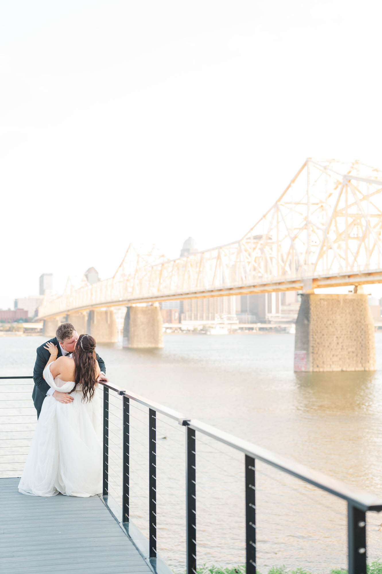 Bride and groom kiss on the porch of the Jefferson at their wedding