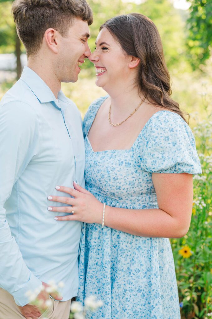 Couple stands together in a field of wildflowers at Beckley Creek Park for their Louisville engagement session.