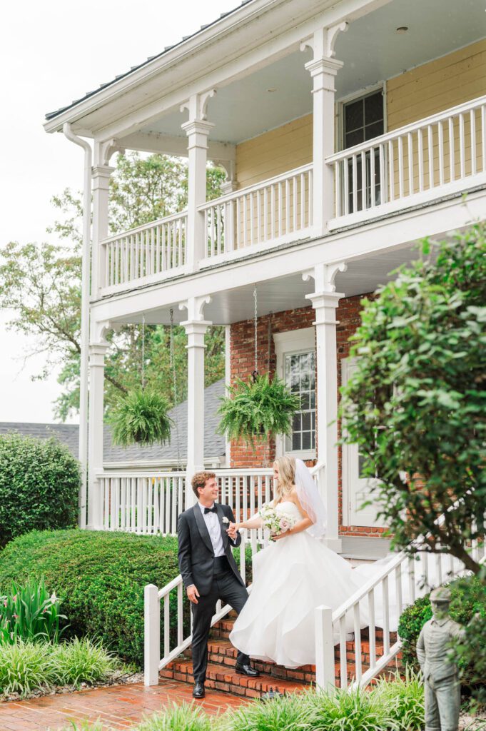 Bride and groom walk down the steps at the Bradshaw Duncan House in Louisville on their wedding day