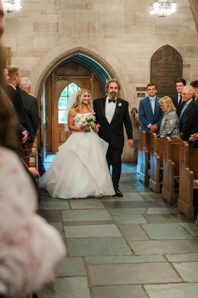 Bride walks down the aisle with her dad