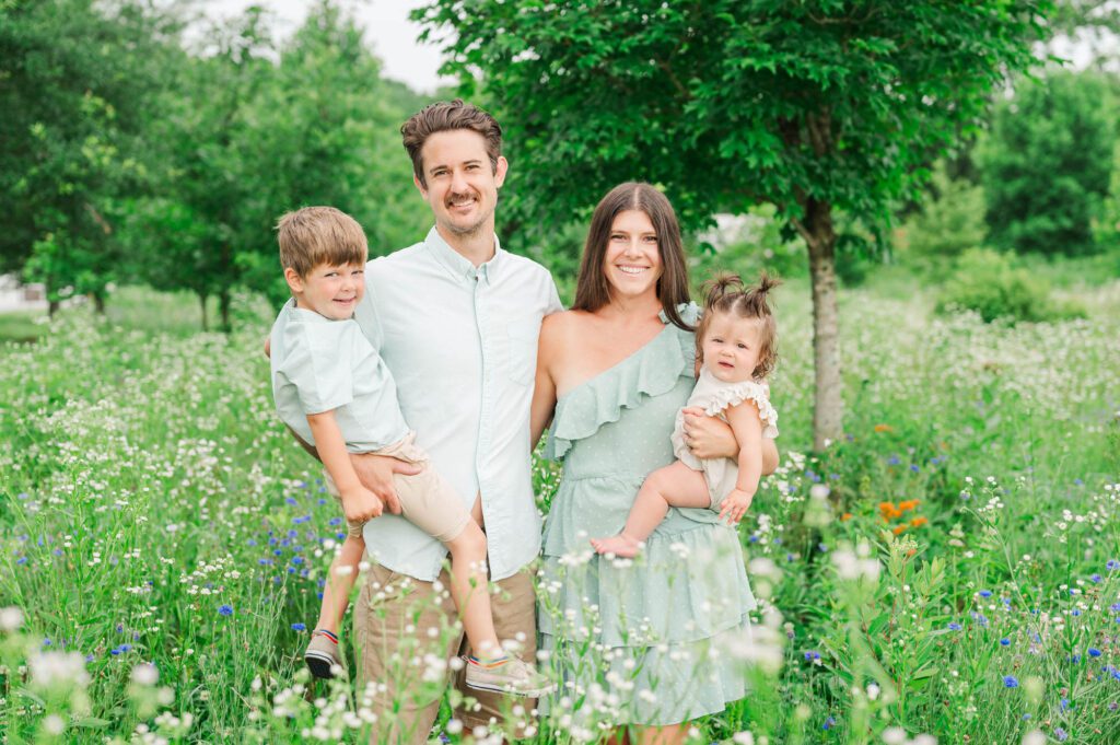 Family poses in wildflowers at Beckley Creek Park in Louisville for their photography session