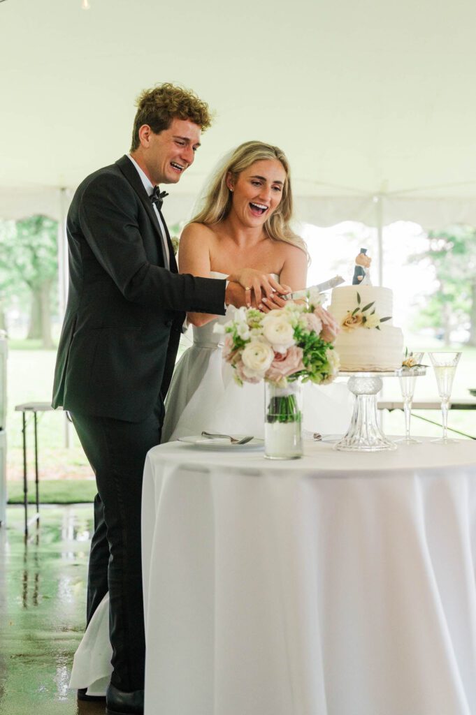 Bride and groom cut the cake at their wedding reception in Louisville, Kentucky