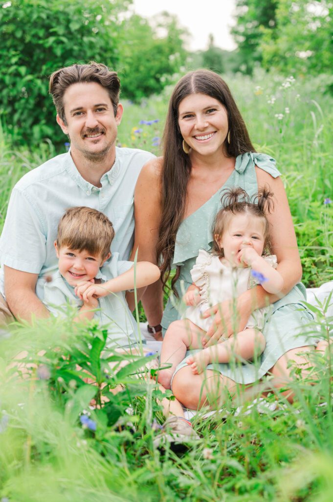 Family poses in wildflowers at Beckley Creek Park in Louisville for their photography session