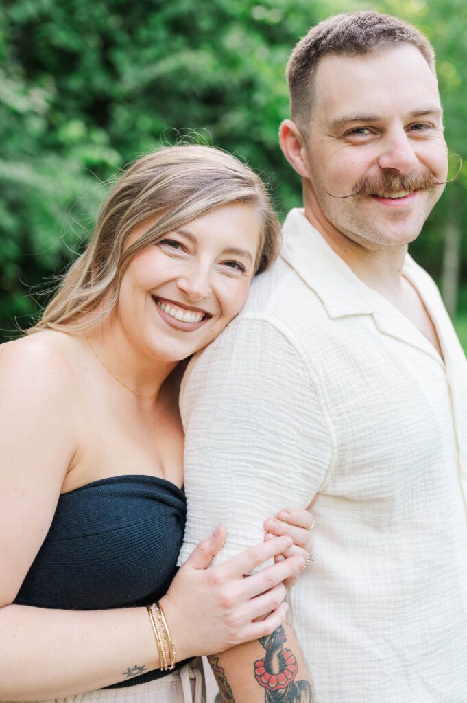 Couple smiles at the camera during their couples session