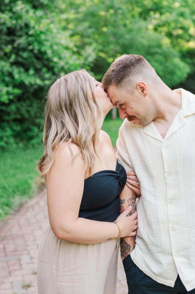 Couple gives forehead kisses during their photo session