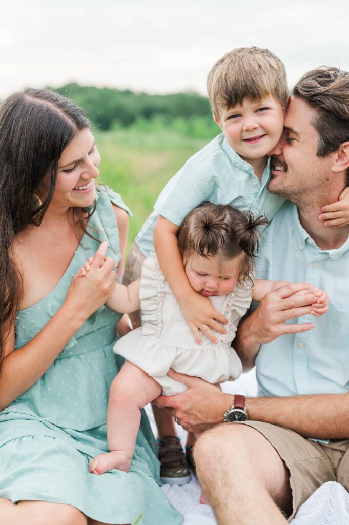 Son hugs dad and sister during their family photo session in Louisville