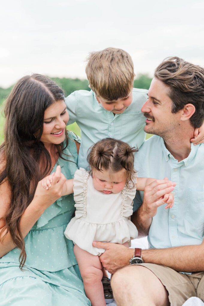 Family sits together for their photo session at Beckley Creek Park in Louisville, KY