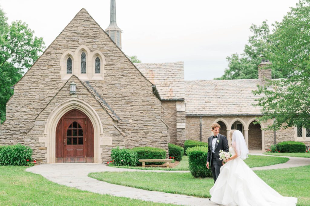 Wedding couple walking in front of the Duncan Memorial Chapel in Louisville, Kentucky