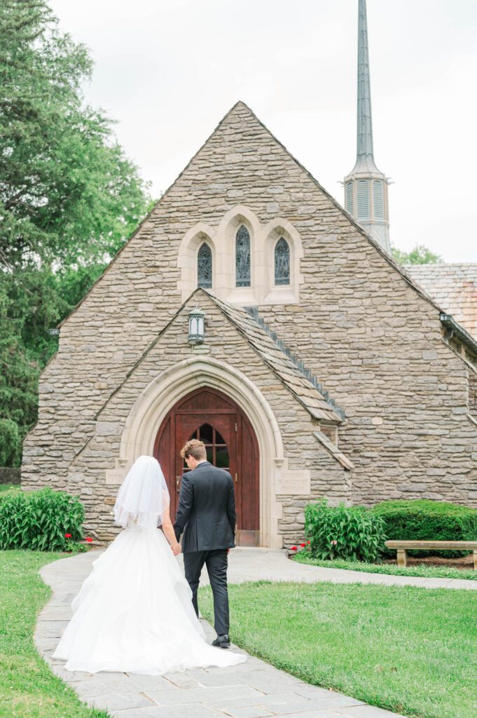 Wedding couple walking in front of the Duncan Memorial Chapel in Louisville, Kentucky