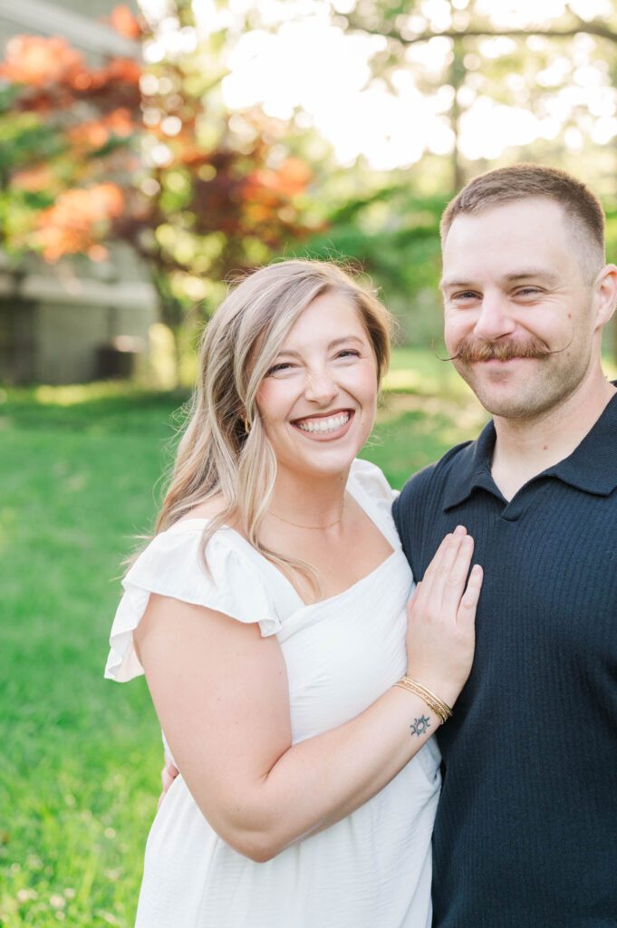 Couple smiles at the camera during their photo session in Louisville