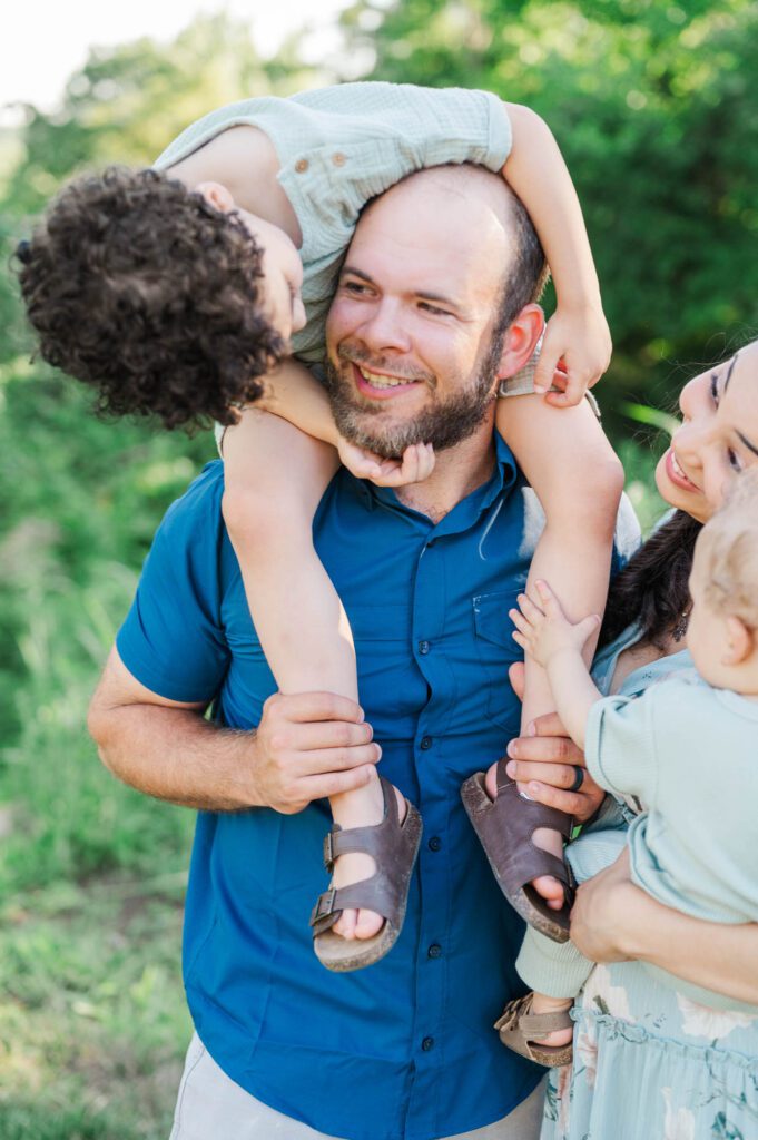 An extended family gets together on family farm for their photo session.