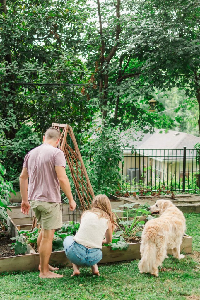 Couple stands in the backyard of their home laughing during their in-home session in Louisville, KY