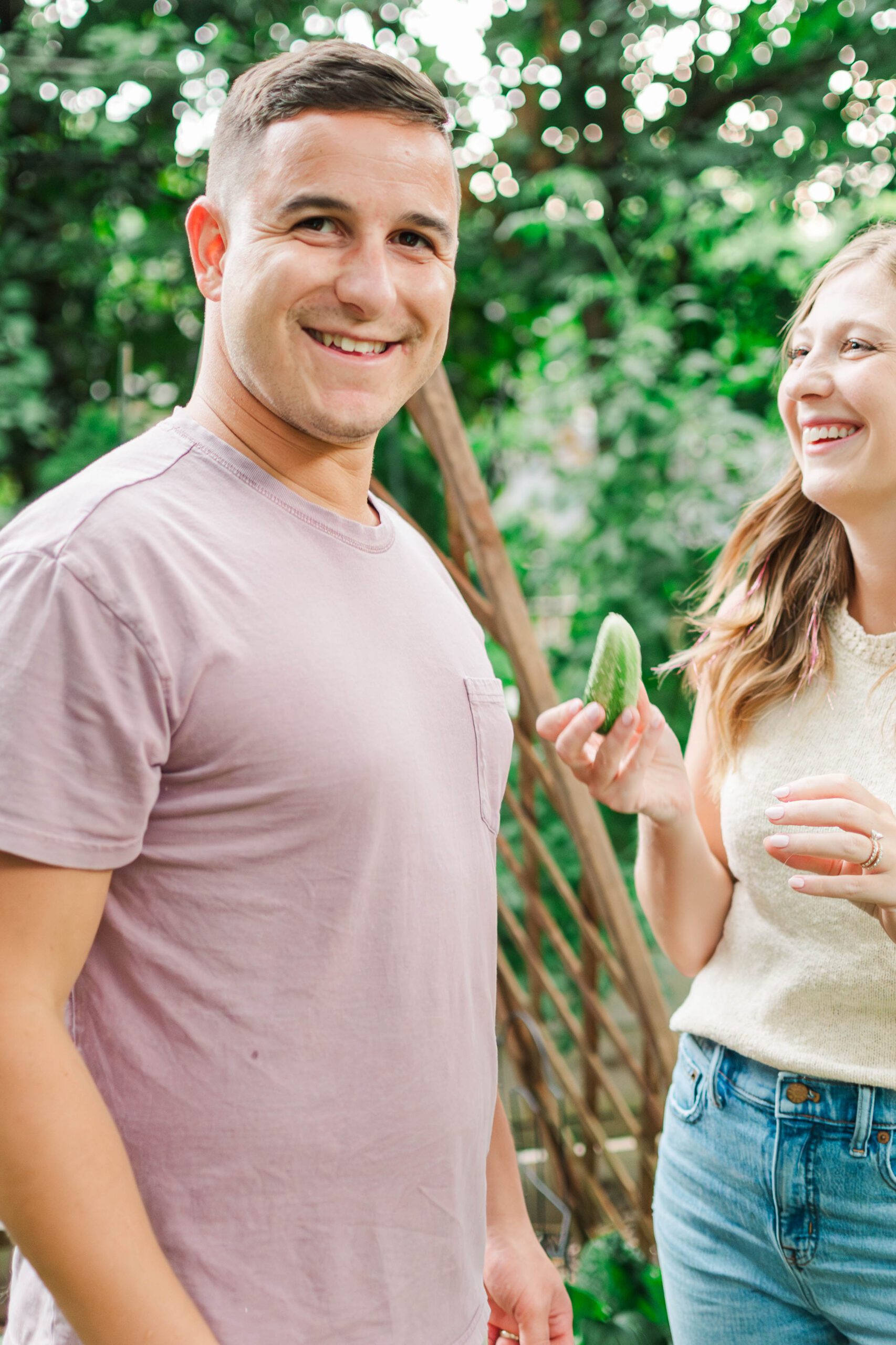 Couple stands in the backyard of their home laughing during their in-home session in Louisville, KY