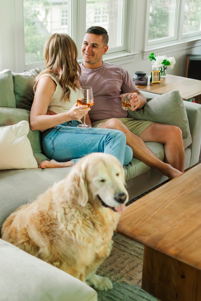 Couple sits together on their couch for their in-home couples session in Louisville, KY