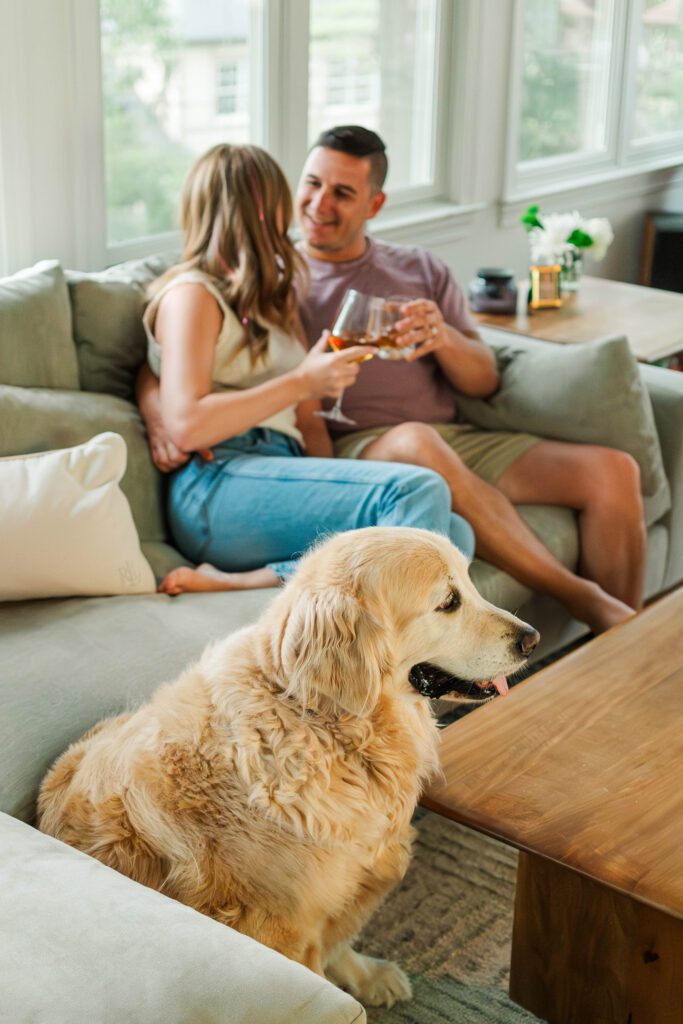 Couple sits together on their couch for their in-home couples session in Louisville, KY